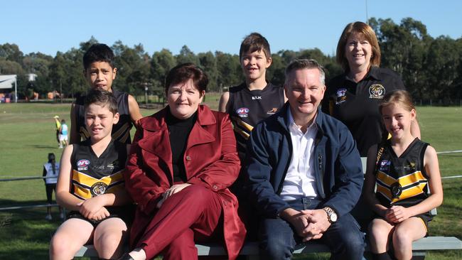 Werriwa federal Labor MP Anne Stanley and Opposition treasury spokesman Chris Bowen with members of the Southwest Tigers Junior Football Club. 