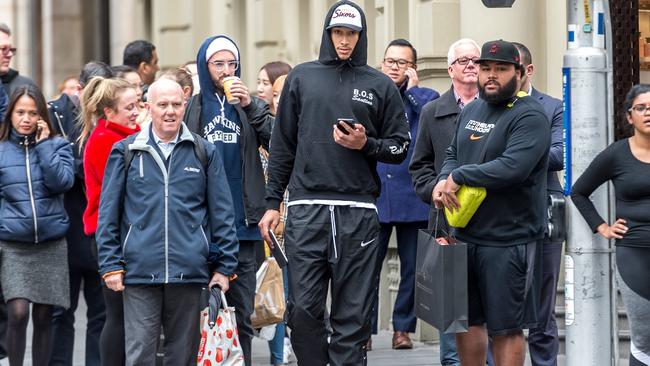 Simmons and his entourage walk through Melbourne's CBD after shopping at Culture Kings. Picture: Jake Nowakowski