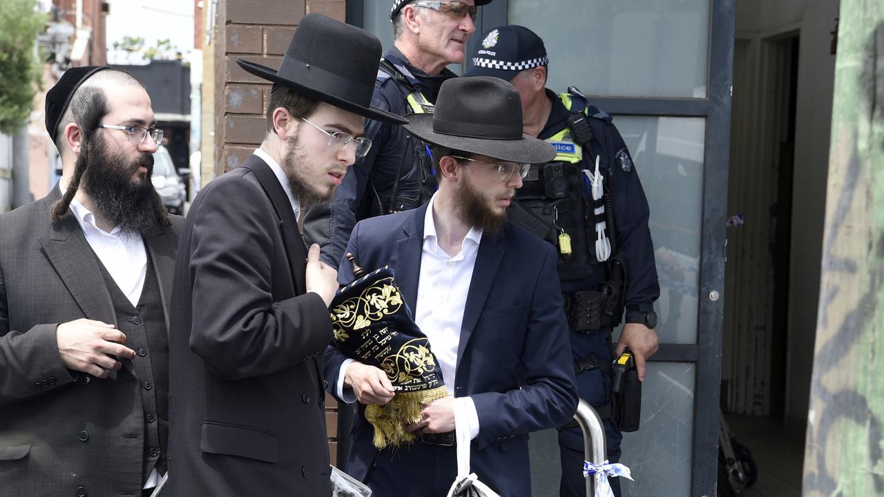 Synagogue members remove religious material from Adass Israel synagogue at Ripponlea after an overnight fire. Picture: NewsWire /Andrew Henshaw