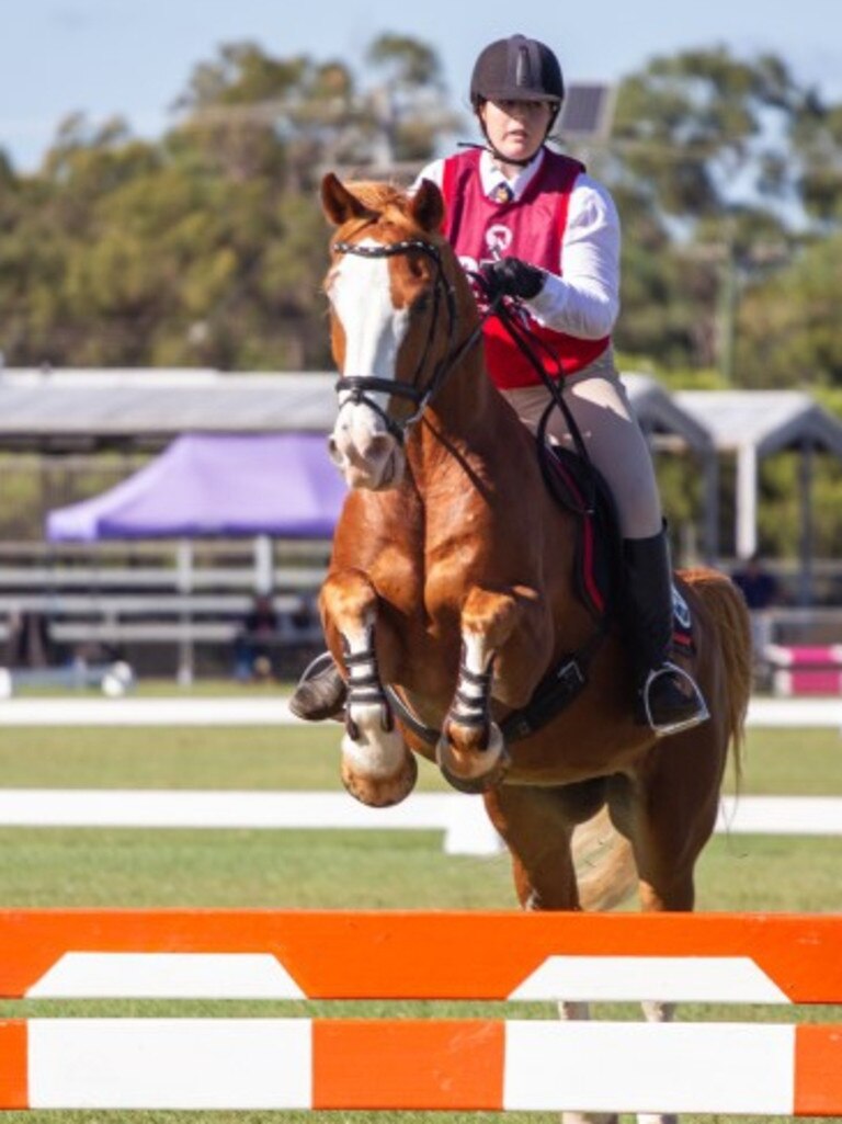 Bonnie Fuller and Thunder Down Under clear the planks at the 2023 PQC State Showjumping Championships.