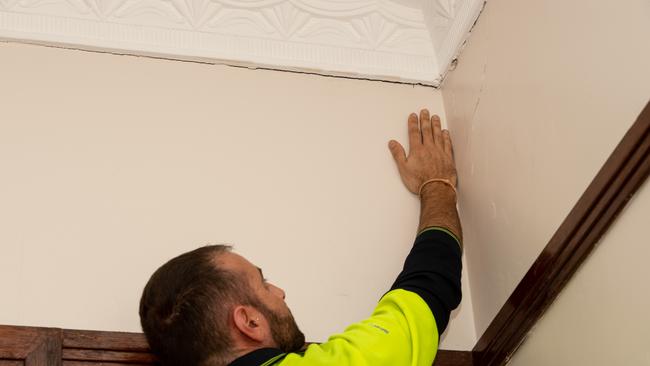 Patrick Borg shows cracks in the cornice of his house which he said were not there when he bought it. Picture: Monique Harmer