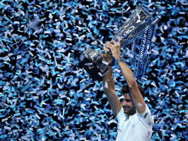 Grigor Dimitrov lifts the trophy as he celebrates victory.