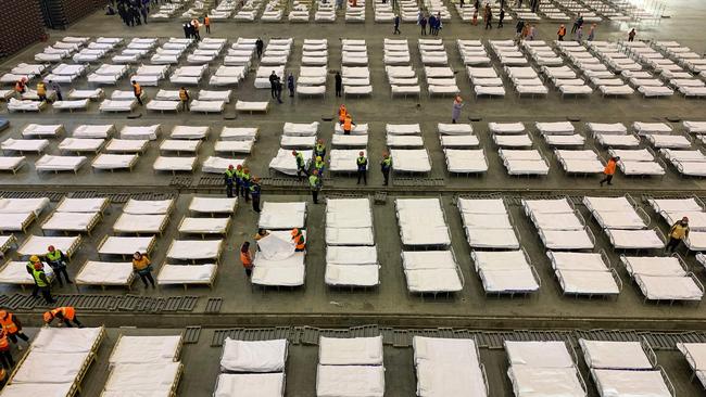 Workers set up beds at an exhibition centre that was converted into a hospital in Wuhan in China's central Hubei province.