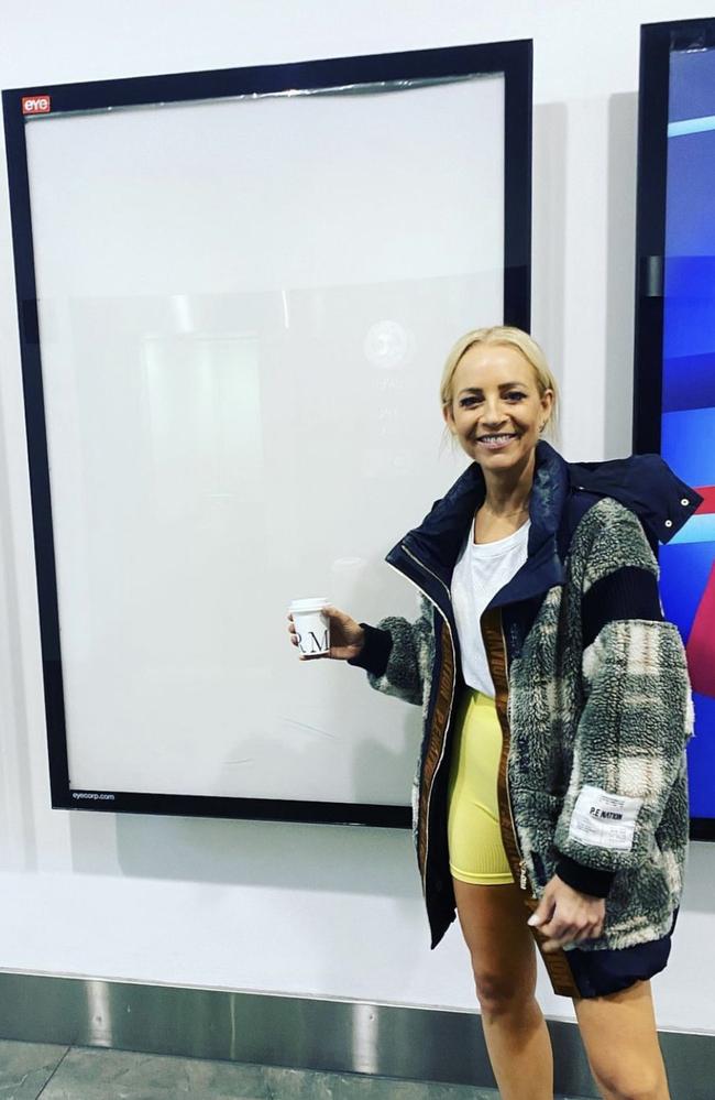 Carrie Bickmore poses next to her empty poster in the Channel 10 hallway.