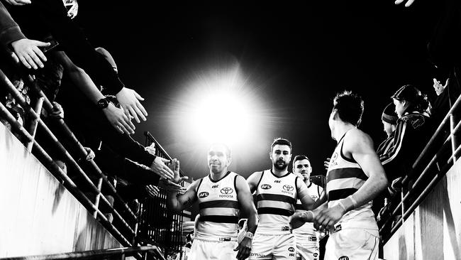 Adelaide’s Eddie Betts leads teammates off the ground on Saturday night. Picture: Bradley Kanaris/Getty Images