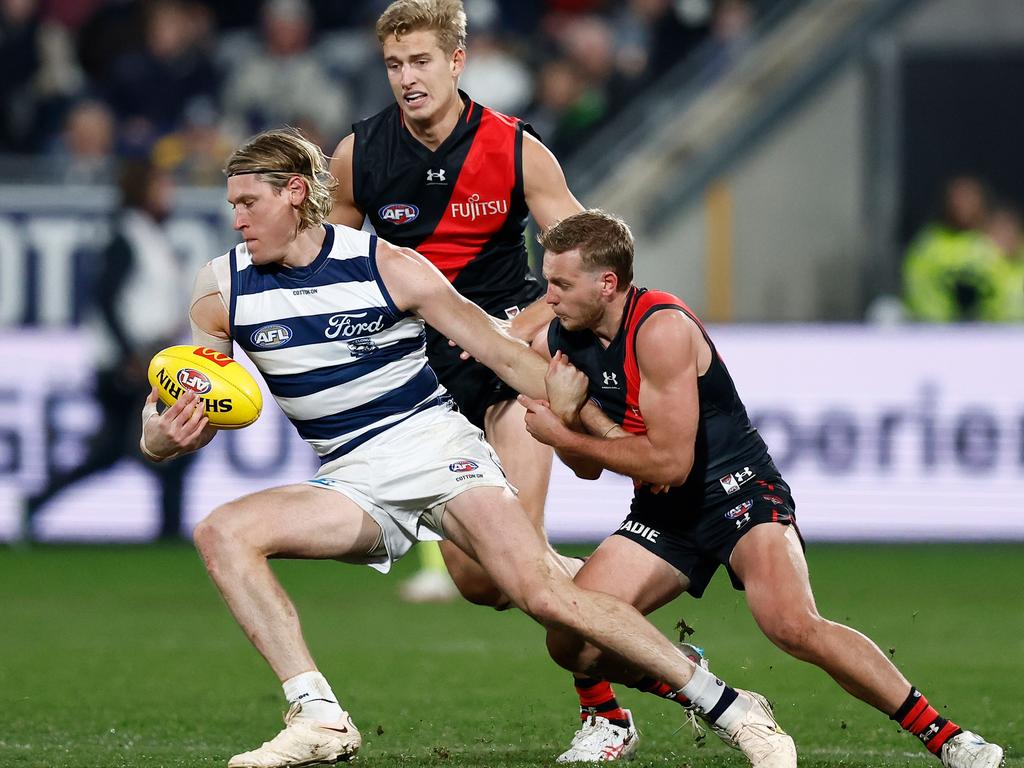 Darcy Parish tackles Mark Blicavs during a clash at GMHBA Stadium.