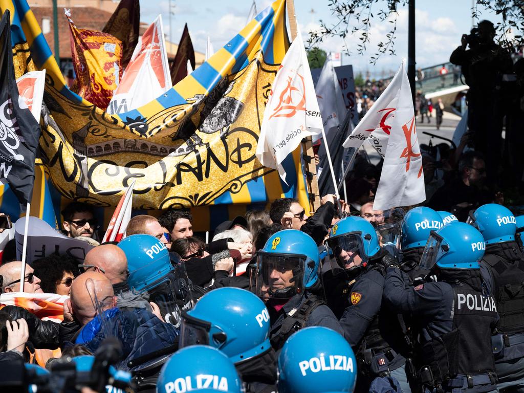 Protesters clash with riot police officers during a demonstration against the new tourist fee. Picture: Marco Bertorello / AFP