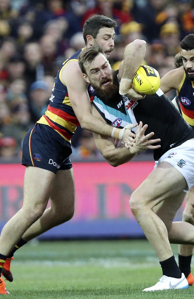 Port Adelaide’s Charlie Dixon under pressure from Adelaide’s Rory Atkins in Showdown 45. Picture: Sarah Reed