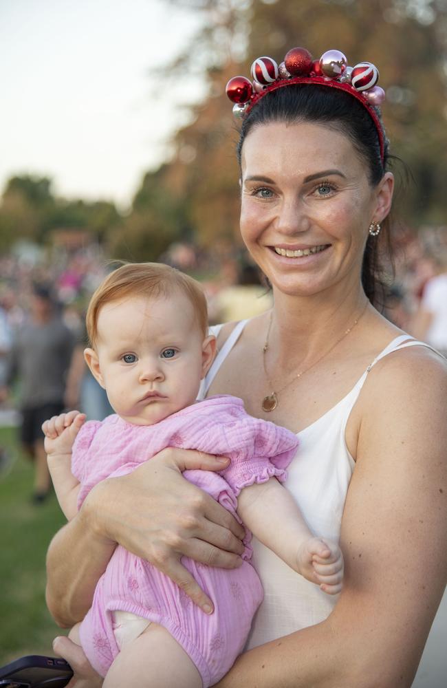 Evie Duggan held by Natalie Bryant. Triple M Mayoral Carols by Candlelight. Sunday 8th December, 2024. Picture: Nev Madsen