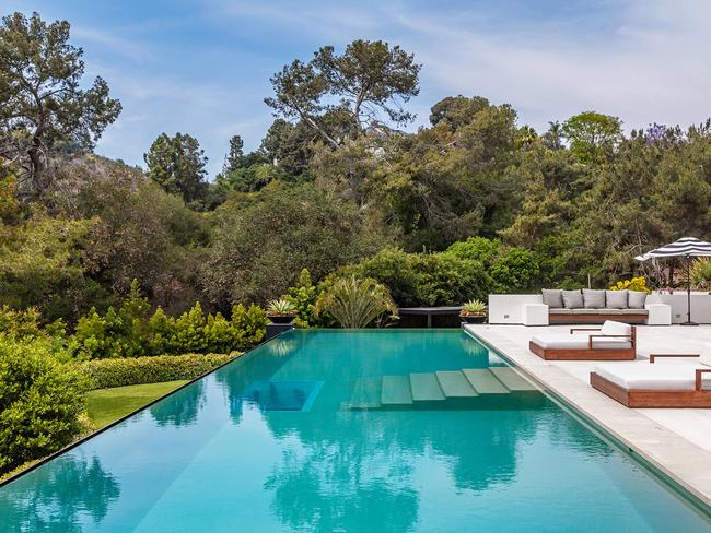 The outdoor pool with sun lounges.