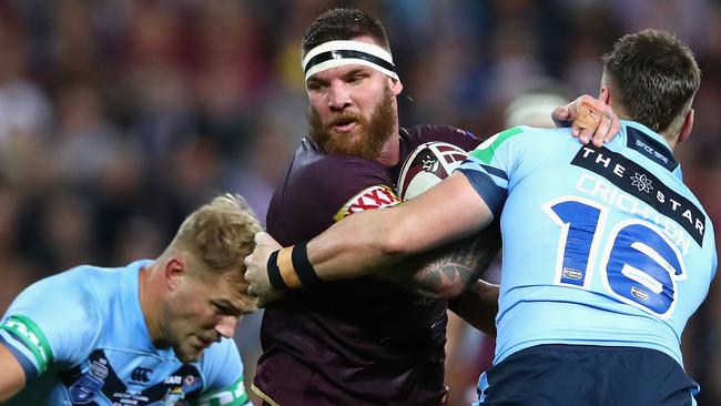 Maroons forward Josh McGuire takes on the Blues defence at Suncorp Stadium.