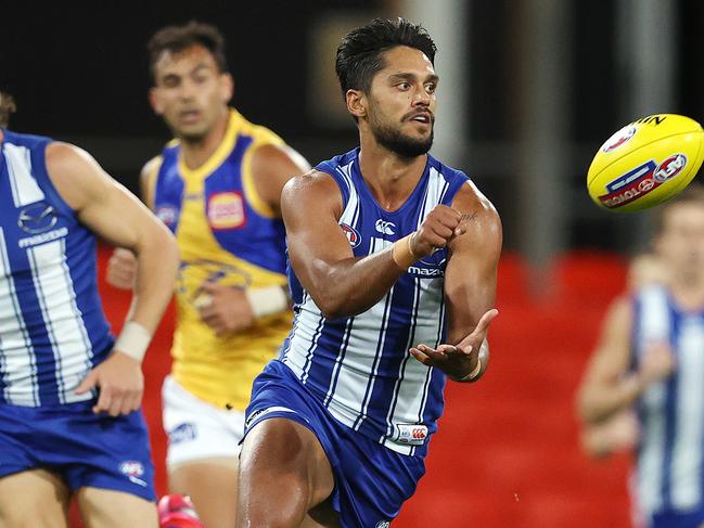 AFL Round 18. 17/09/2020. North Melbourne vs West Coast Eagles at Metricon stadium, Gold Coast. Tasmanian Aaron Hall of the Kangaroos clears by hand. Pic: Michael Klein