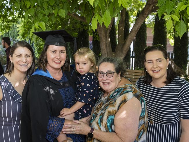 Bachelor of Nursing graduate Renee Maher holding Molly Maher is congratulated by family (from left) Krystle Theodosis, Michelle Schneider and Jessica Sondergeld at a UniSQ graduation ceremony at Empire Theatres, Tuesday, October 31, 2023. Picture: Kevin Farmer