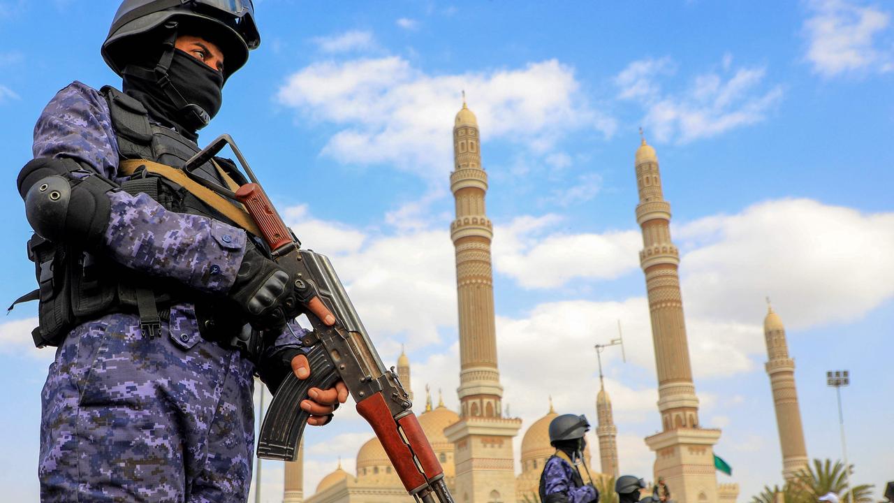 Yemen's Huthi-affiliated security forces stand guard during a march in solidarity with the people of Gaza in the capital Sanaa on December 15, 2023. (Photo by MOHAMMED HUWAIS / AFP)