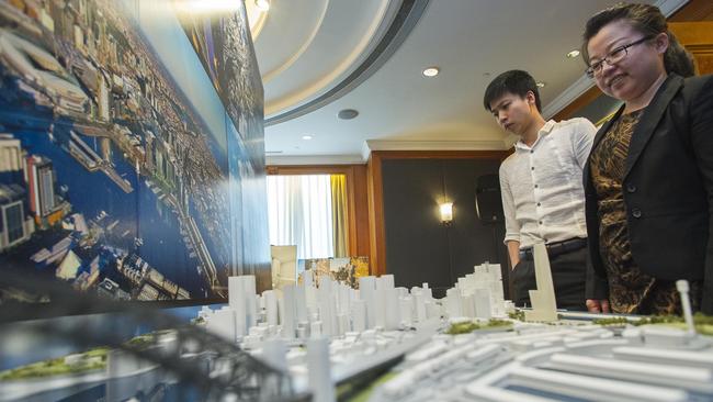 Guests examine a scale model of central Sydney at a property showcase by Lendlease at Shanghai’s Four Seasons Hotel in 2014.