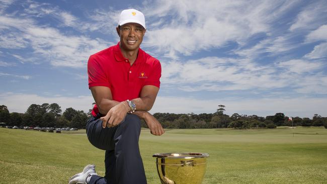 Woods poses with the Presidents Cup, which he will compete for next year. Picture: Michael Klein