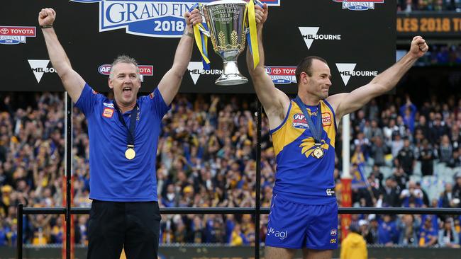 Adam Simpson and Shannon Hurn lift the cup. Picture: Michael Klein