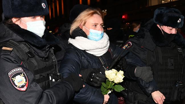 A woman is led away by police. Picture: Kirill KUDRYAVTSEV / AFP