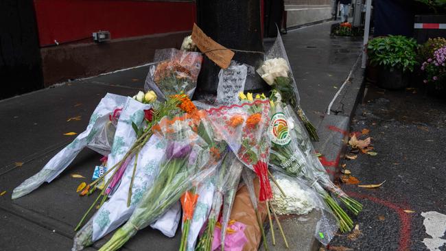 Floral tributes are left for actor Matthew Perry outside the apartment building which was used as the exterior shot in the TV show Friends in New York. Picture: Adam Gray/AFP