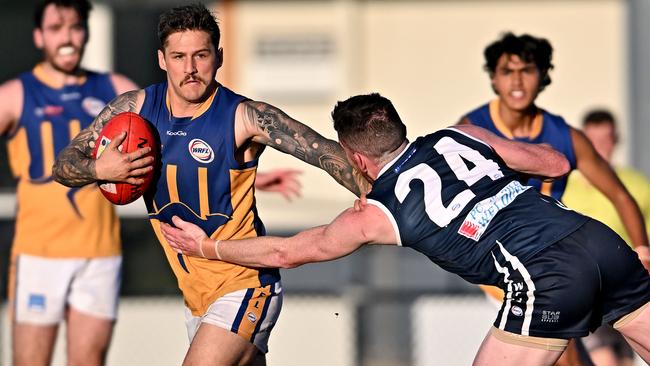 WRFL: Hoppers Crossing’s Ethan Henley tries to stop Taygen Dennison of Sunshine. Picture: Andy Brownbill