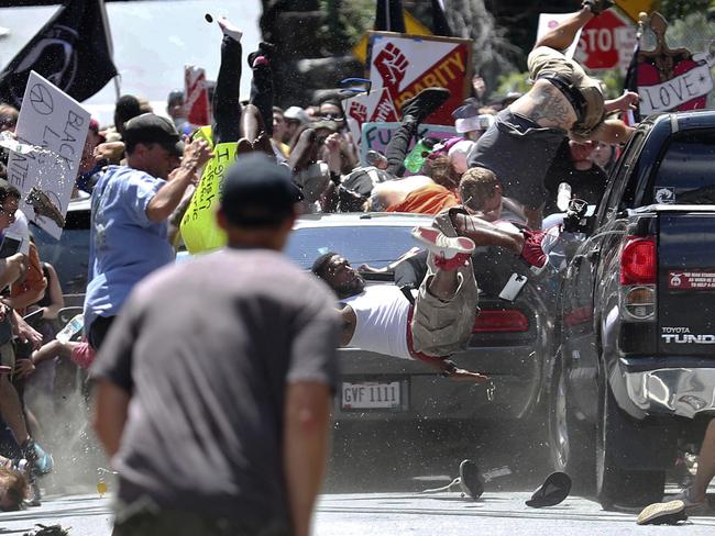 People fly into the air as a vehicle drives into a group of protesters demonstrating against a white nationalist rally in Charlottesville, Virginia on Saturday. Picture: Ryan M. Kelly/The Daily Progress via AP