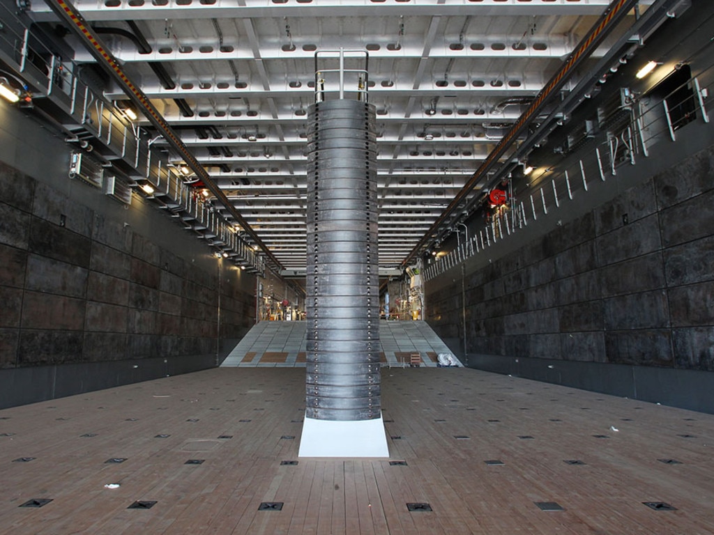 The well dock has a stern ramp door providing access to landing craft with a fixed ramp of steel beach between the well dock and heavy vehicle/cargo deck.