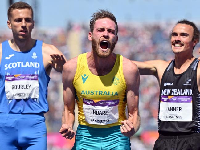 TOPSHOT - Australia's Oliver Hoare (C) reacts after winning the men's 1500m final athletics event at the Alexander Stadium, in Birmingham on day nine of the Commonwealth Games in Birmingham, central England, on August 6, 2022. (Photo by Glyn KIRK / AFP)