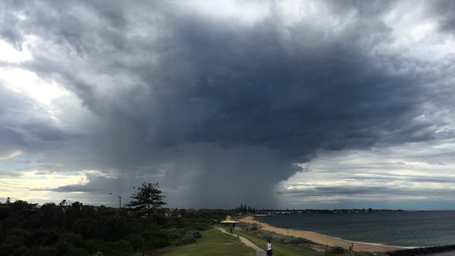 Storm clouds build at Point Ormond, Elwood on Friday morning. Picture: Andrew Watkins