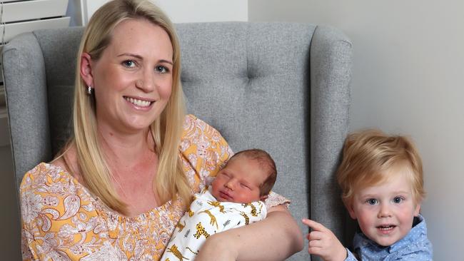 Stephanie Kearney at her Pimpama home with her newborn son Byron and two-year-old son Hudson. Stephanie helped deliver her own baby during C-section. Picture Glenn Hampson