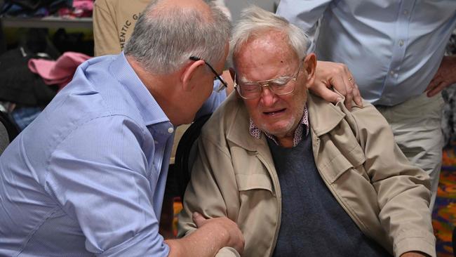 Prime Minister Scott Morrison comforts 85-year-old resident Owen Whalan at an evacauation centre in Taree, 350km north of Sydney. Picture: Peter Parks