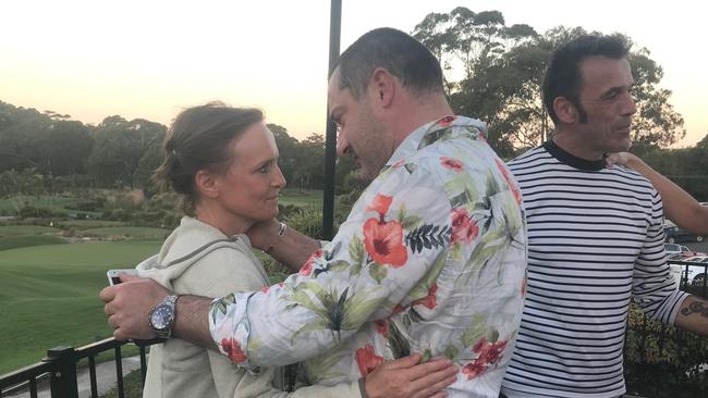 Mother Vinciane Delforge is comforted by a volunteer and father Laurent Hayez talks to a community member. Picture: Supplied