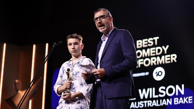 Chris Woods and his son Digby accepts the AACTA Award for BestComedy Performer on behalf of Cal Wilson for The Great Australian Bake Off. Picture: Brendon Thorne/Getty Images for AFI