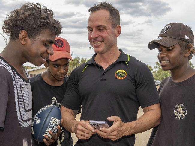 26/04/2023: Alice Springs based Yipirinya School principal Gavin Morris with students on the school grounds. Malikai Hayes, Keylin Peters (red cap), Adrian Nelson (black cap) & Jahquille Stuart (rat tail). PIC: Grenville Turner