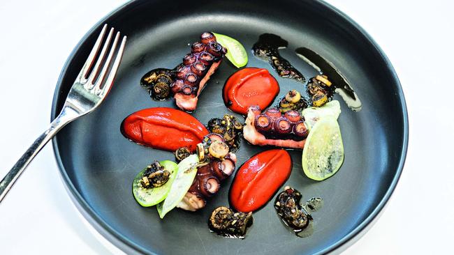 Grilled octopus with pickled tomatillo, romesco sauce and a black spring onion vinaigrette. Picture: Jesse Marlow