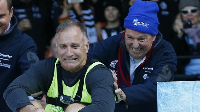 Daniher gives great mate Tim Watson some help down the slide in the 2015 Big Freeze at the ‘G. Pic: Michael Klein