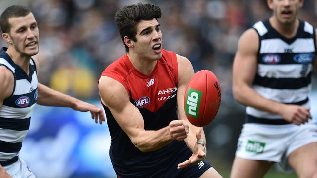 Christian Petracca fires off a handball against Geelong.