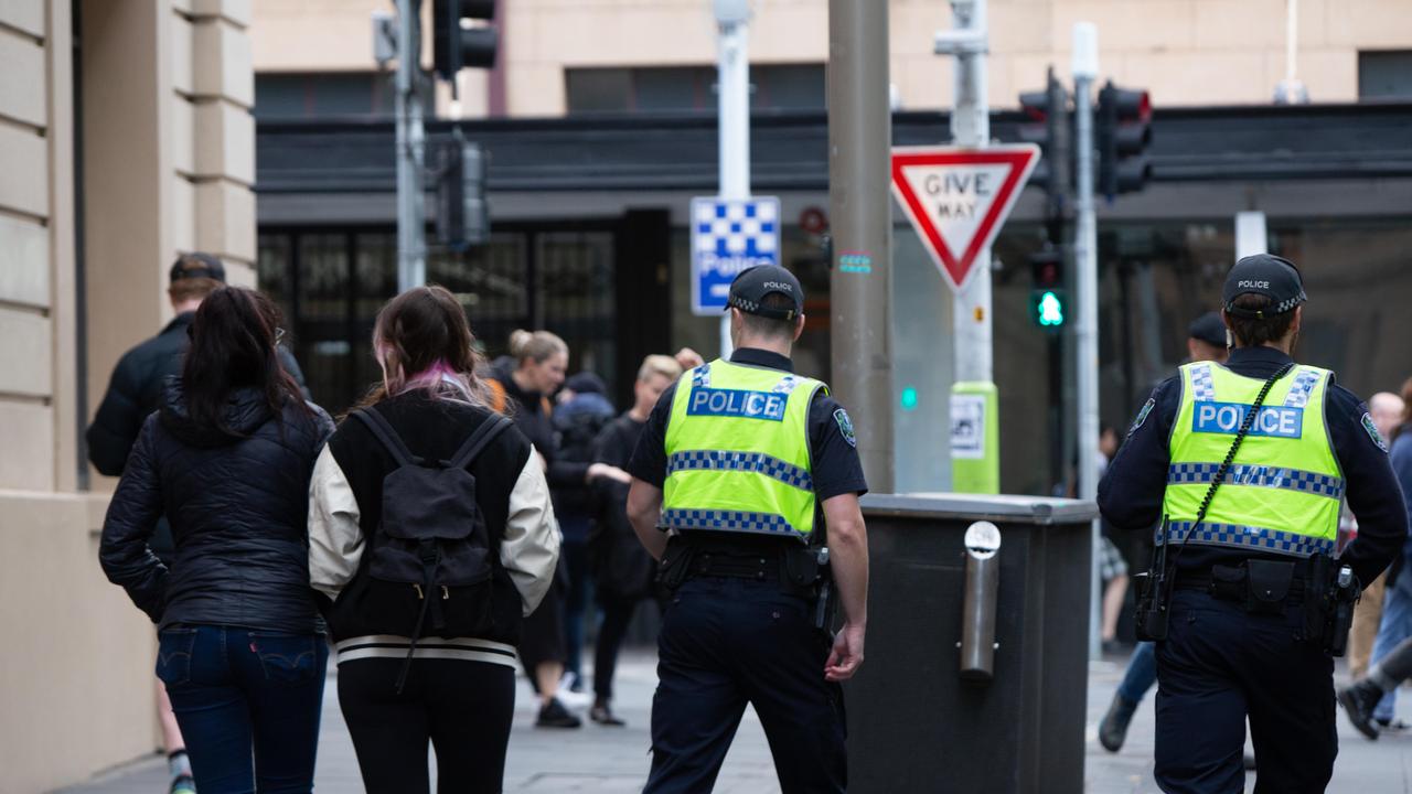 The officers take Miss Blanco and her colleague to Hindley St police station where she gave a statement. Picture: Brett Hartwig