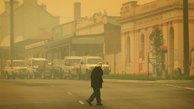 Smoke is heavy and visibility low down the main street of Orbost in fire ravaged East Gippsland. Picture: Mark Stewart