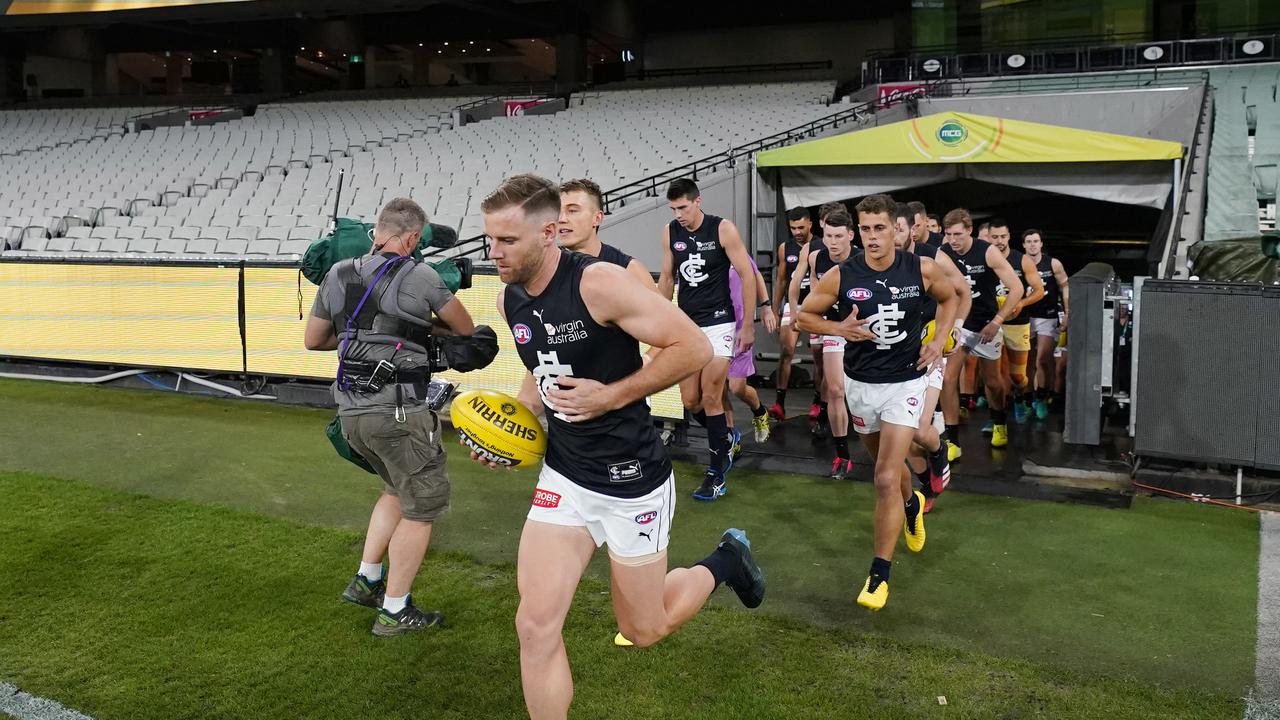 Sam Docherty leading Carlton out to the empty MCG on his long-awaited AFL return.