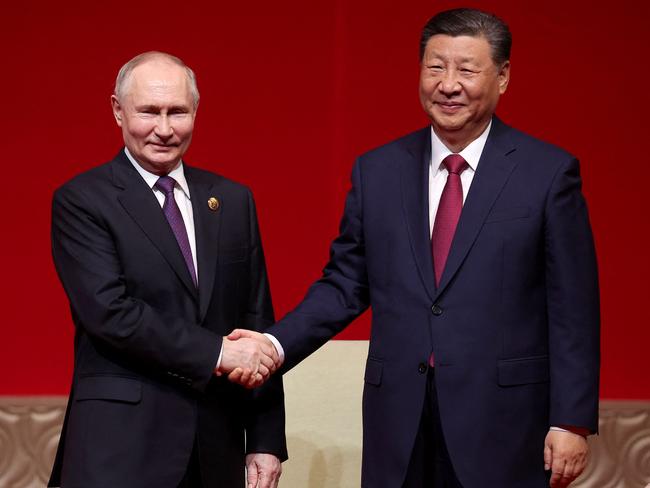 TOPSHOT - In this pool photograph distributed by the Russian state agency Sputnik, Russia's President Vladimir Putin and China's President Xi Jinping attend a concert marking the 75th anniversary of the establishment of diplomatic relations between Russia and China and opening of China-Russia Years of Culture at the National Centre for the Performing Arts in Beijing on May 16, 2024. (Photo by Alexander RYUMIN / POOL / AFP) / ** Editor's note : this image is distributed by Russian state owned agency Sputnik **