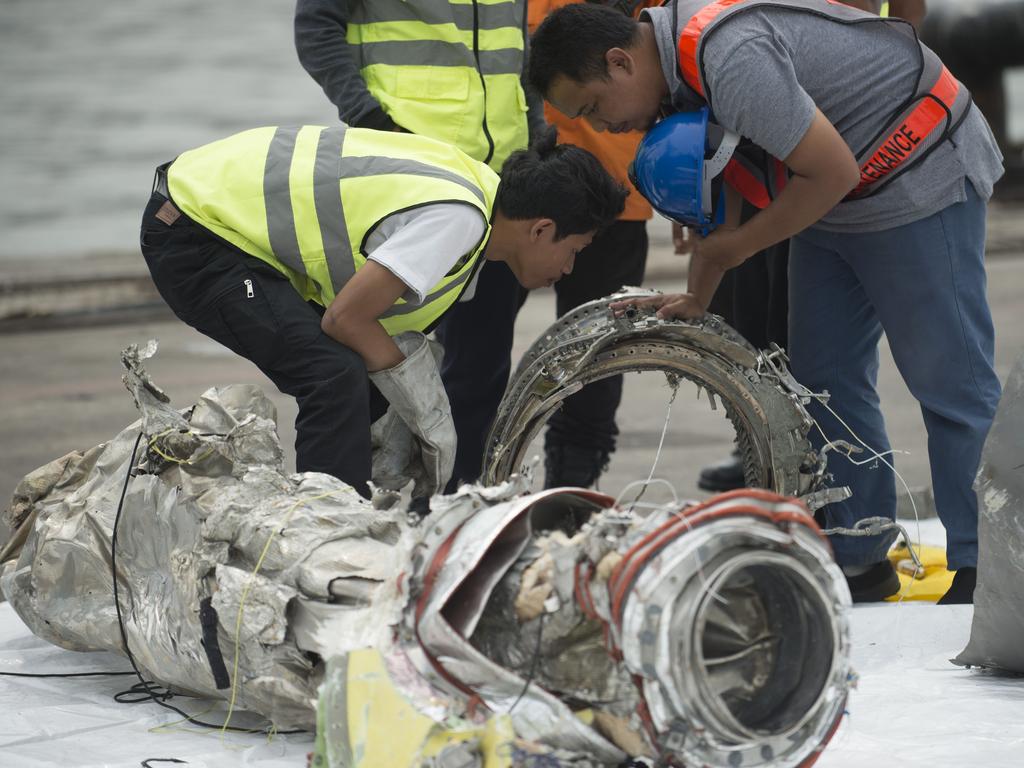 Investigators examine engine parts from the ill-fated Lion Air flight JT 610. Picture: Bay Ismoyo/AFP