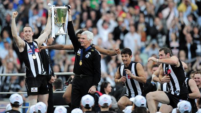 2010 Collingwood captain Nick Maxwell with coach Mick Malthouse lifting the premiership cup.