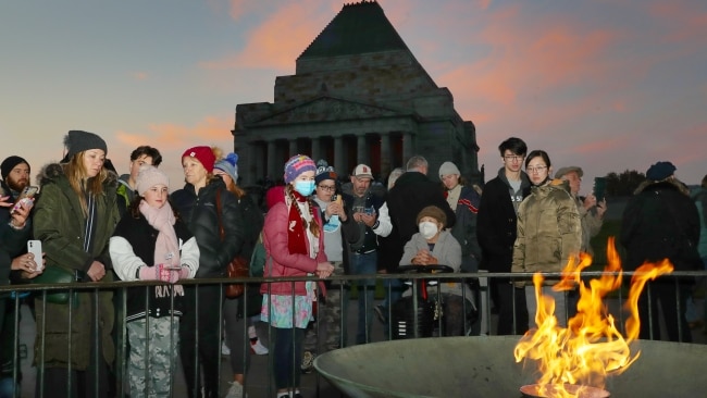 Families gather around the flame as they reflect on the sacrifices of tens of thousands of soldiers. Picture: David Crosling