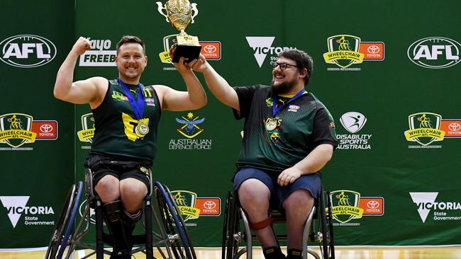 MELBOURNE, AUSTRALIA - NOVEMBER 05: Josh Christian of Tasmania and Tasmania Head Coach Joe Chivers hold the premiership cup aloft after winning the Division 2 Grand Final match between Tasmania and NSW/ACT during the 2023 Toyota AFL Wheelchair National Championships Grand Final Day at State Netball Hockey Centre on November 05, 2023 in Melbourne, Australia. (Photo by Josh Chadwick/AFL Photos/via Getty Images)