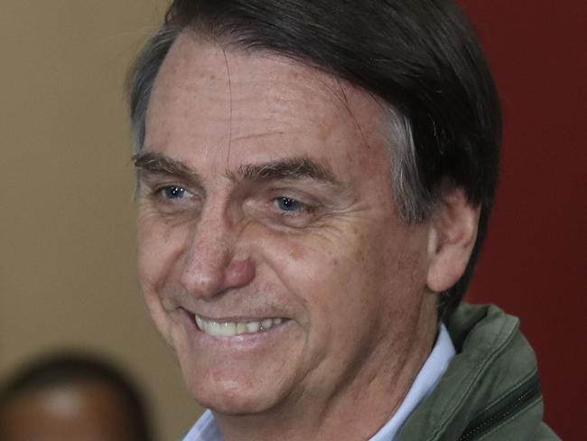 Brazil's right-wing presidential candidate for the Social Liberal Party (PSL), Jair Bolsonaro votes during runoff elections, in Rio de Janeiro, Brazil, on October 28, 2018. (Photo by RICARDO MORAES / POOL / AFP)