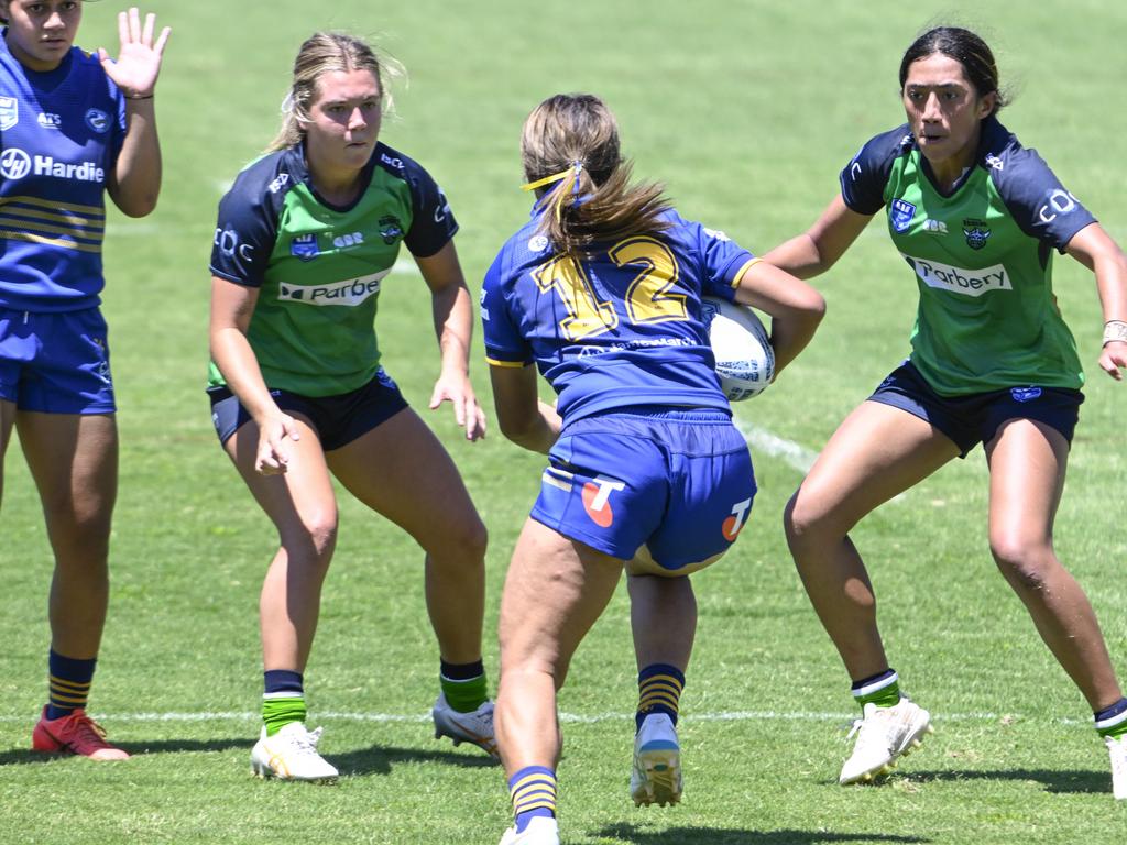 Matoisha Kalepo charges at Halle Constable (left) and Sabrina Marela. Picture: Martin Ollman