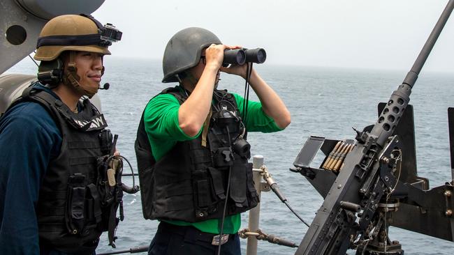 This handout picture taken by the US Navy shows US sailors aboard an amphibious assault ship as they keep watch on the Strait of Hormuz.