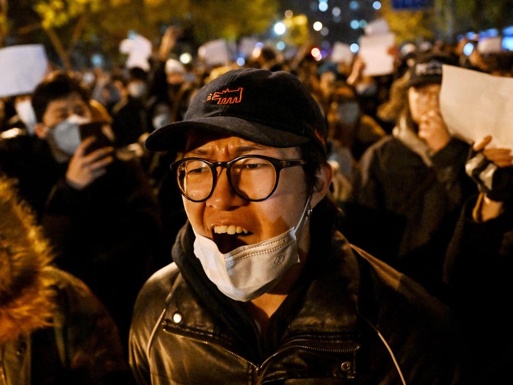 Protesters march along a street during a rally for the victims of a deadly fire as well as a protest against China's harsh Covid-19 restrictions in Beijing. Picture: AFP