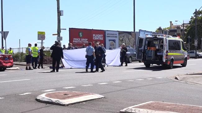 Police set up a privacy screen following a multi-vehicle accident, a carjacking and a stabbing. Picture: TNV