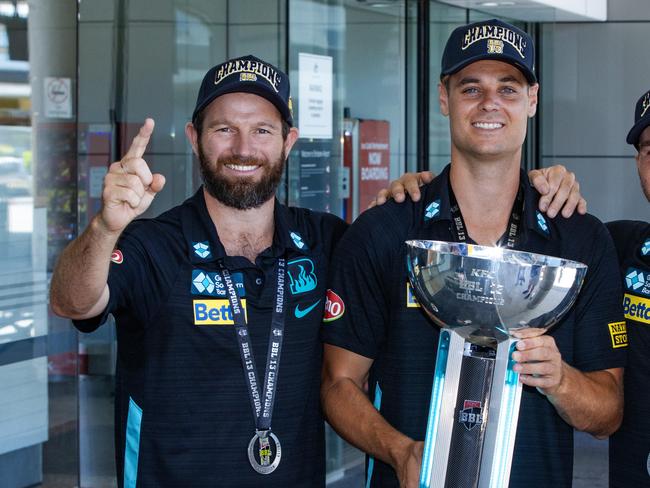 BBL Champions of 2023/24 Brisbane Heat arrive at Brisbane Airport.Michael Neser, Spencer Johnson and Josh Brown with the BBL trophy at Brisbane Airport.Picture: Nigel Hallett